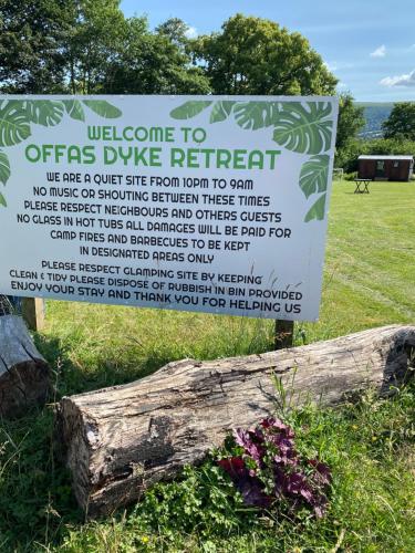 a sign for a disservice to fires dive retreat at luxury pod with hot tub in Clodock