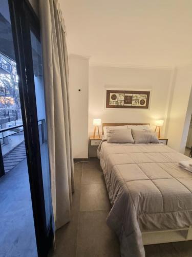 a bedroom with a large bed and a window at Monoambiente parque p in Villa María