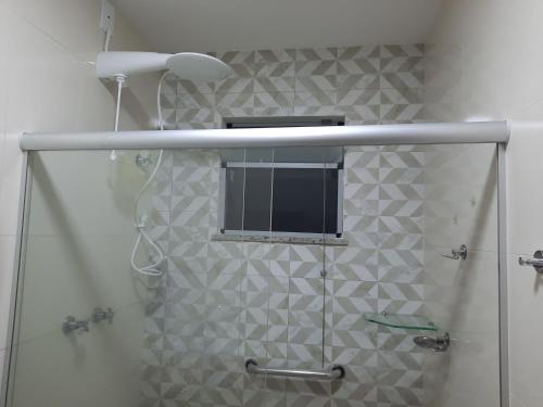 a shower with a window in a bathroom at Casa do Mutá in Porto Seguro