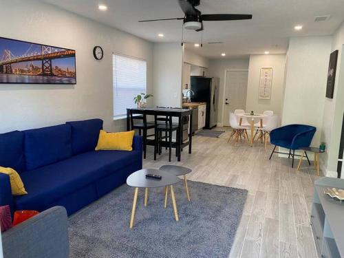 a living room with a blue couch and a kitchen at Lovely 2-Bedrooms Central Clearwater Apartment in Clearwater