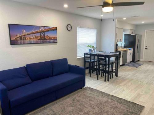 a living room with a blue couch and a kitchen at Lovely 2-Bedrooms Central Clearwater Apartment in Clearwater