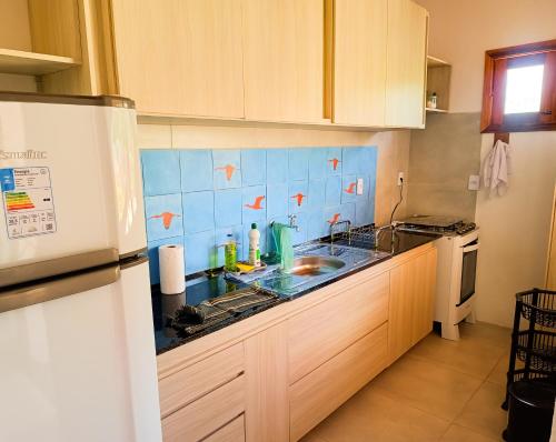 a kitchen with a sink and a counter top at Flats Macapá Meu Amor in Luis Correia