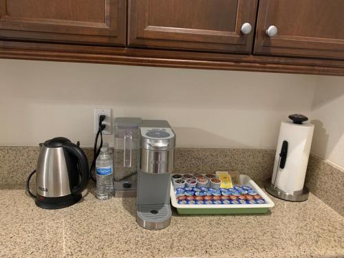 a counter with a coffee maker and a blender on a counter at LuxHome Suites in Mansion in Riverside
