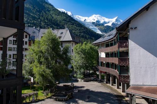 a view of a town with mountains in the background at Nice Apt With Mountain View At The Foot Of Slopes in Chamonix-Mont-Blanc