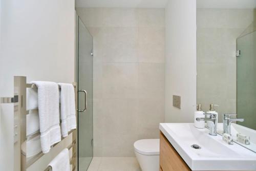 a bathroom with a sink and a toilet at Worcester Terrace Eleven - Christchurch Holiday Homes in Christchurch