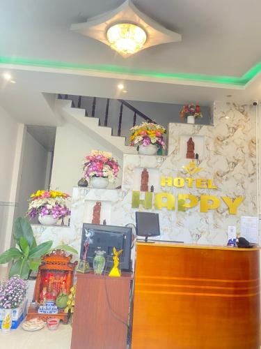 a hotel lobby with a hotel happy sign on the wall at Happy 1 Hotel Binh Duong in Bến Cát