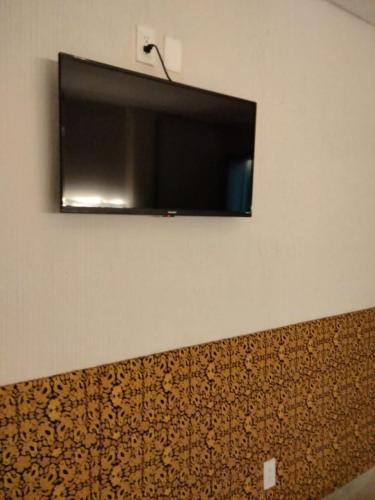 a flat screen tv hanging on a wall at Las heliconias 3 moderno loft in Oaxaca City