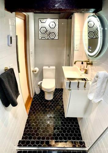 a bathroom with a white toilet and a sink at Live in this iconic East Side lower level unit in Providence