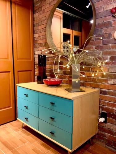 a dresser with a mirror on top of it at Live in this iconic East Side lower level unit in Providence