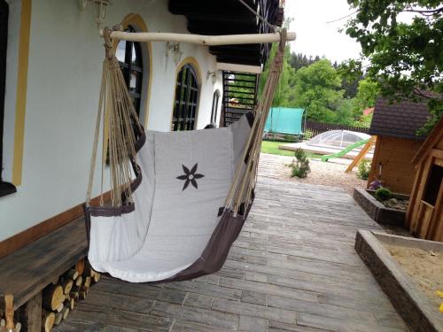 a hammock hanging from the side of a house at Wellness Pension Fulda Černý Důl in Cerny Dul