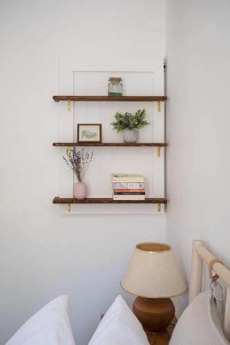 a room with shelves on the wall and a lamp at The Darcie House - cozy, pet-friendly home in PEC in Picton
