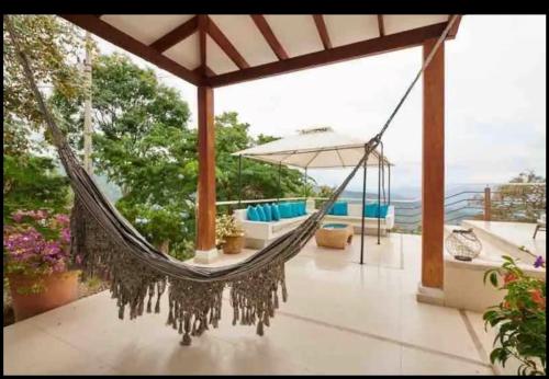 a hammock on a house with a view at Finca San Pedro in La Mesa