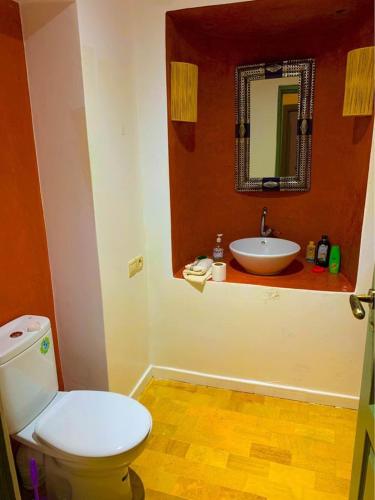 a bathroom with a white toilet and a sink at Bienvenue à la Villa Luxe de 3 Suites pour Location Journée ! in Marrakesh