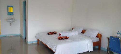 a bedroom with a bed with two bags on it at FARILA LODGE in Ende