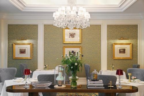 a dining room with a table and a chandelier at The Ritz-Carlton Beijing in Beijing