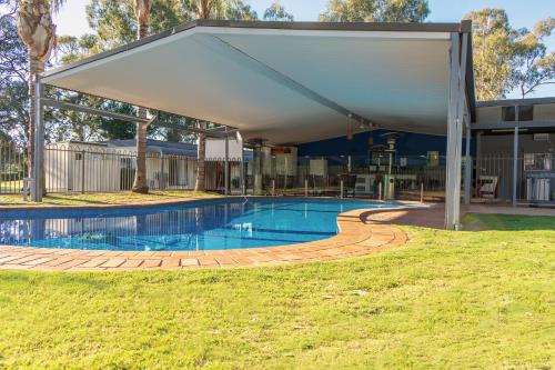 a covered swimming pool with a pavilion at Deni Golf Resort in Deniliquin
