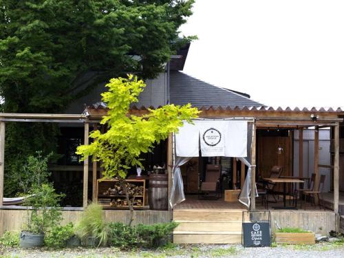 a house with a sign in front of it at 富士山ビューの貸切宿 屋根付きウッドデッキでbbq可 浅間神社近く in Fujiyoshida