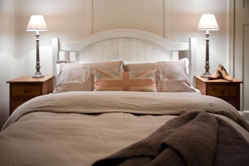 a bedroom with a large bed with two lamps at Hepburn View in Hepburn Springs