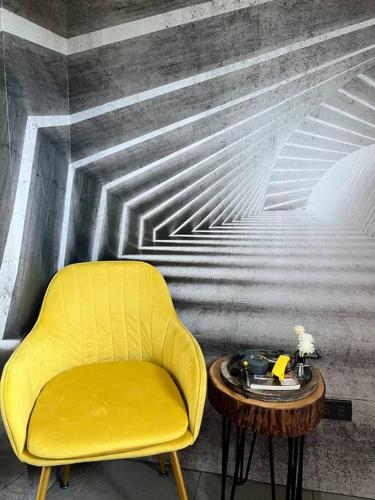 a yellow chair and a table in a room at 17 Riada Villa in San Juan