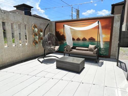 a outdoor patio with a couch and a swing at 17 Riada Villa in San Juan