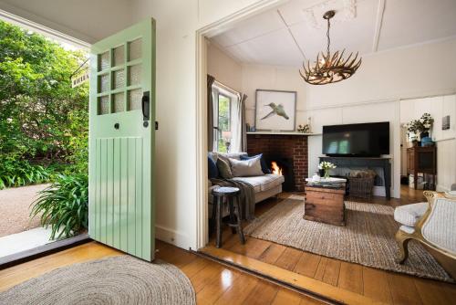 a living room with a green door and a couch at Illoura in Hepburn Springs