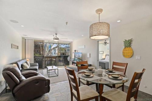 a living room with a couch and a table with chairs at Pineapple Paradise - Mission Beach - Stunning in San Diego