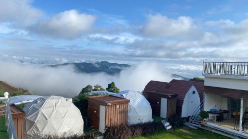 a group of domes with a view of the mountains at Mon Jam Memory Camp in Mon Jam