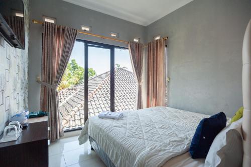 Postel nebo postele na pokoji v ubytování Urbanview Resort Syariah Khansa Cisarua Puncak by RedDoorz