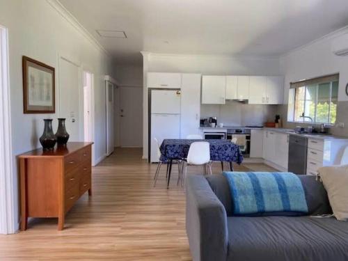 a living room with a couch and a kitchen at Eos 2 in Esperance