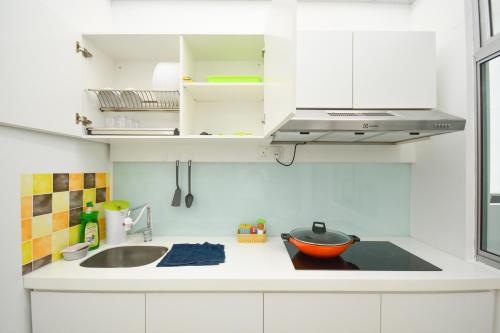 a kitchen with white cabinets and a bowl on the counter at Manhattan Theme Suite by Nest Home at Austin Heights in Johor Bahru