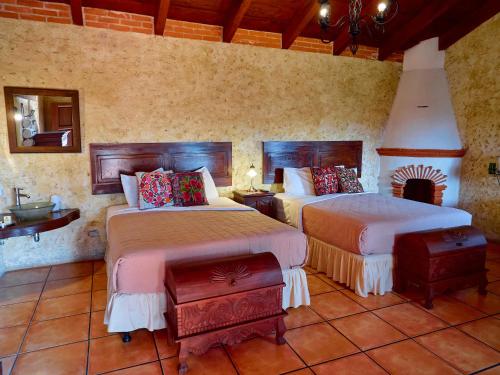 a bedroom with two beds in a room at Naif Boutique Hotel in Antigua Guatemala