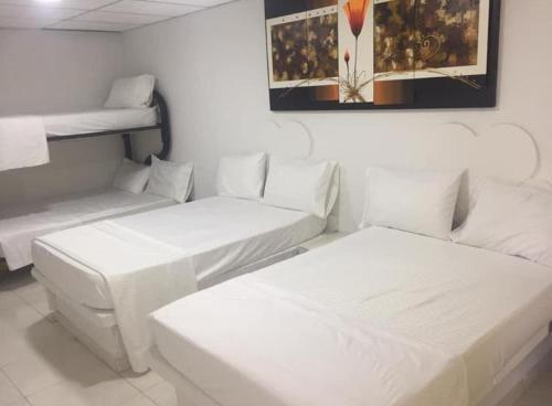 a room with two beds and two bunk beds at Hotel Quinta Ana María in Melgar