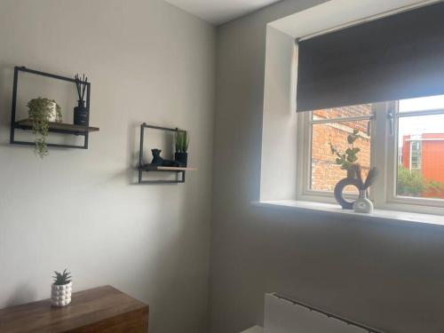 a white room with a window with a window shade at Fern House - 2bedroom house Free Parking Town centre by Shortstays4u in King's Lynn