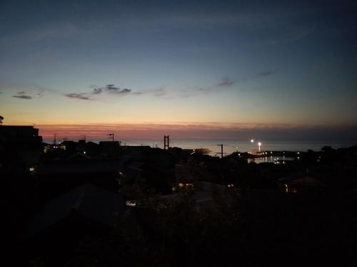 a view of a city at sunset at Shorenkan Yoshinoya in Kyotango