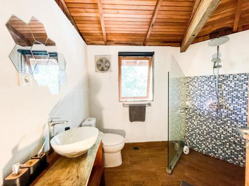 a bathroom with a sink and a toilet and a shower at Villa Russerangan Grand Opening in Praya