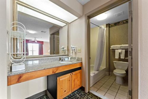 a bathroom with a sink and a toilet and a mirror at Scottsdale 2 bd 2 ba furnished apt King beds in Scottsdale
