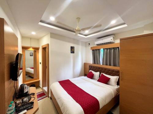 a hotel room with a bed with red pillows at AIR VALLEY INN in Guwahati