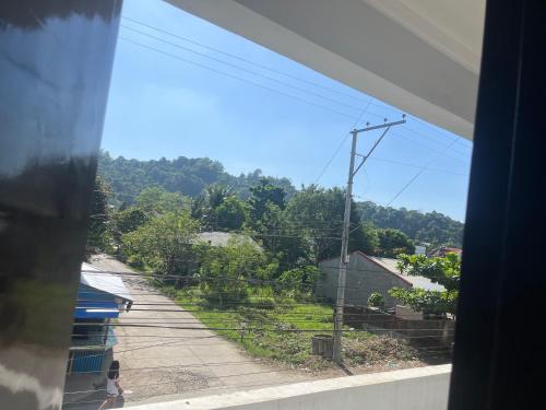 a view from a window of a street and trees at Oppas Studio Unit near Sm uptown in Cagayan de Oro