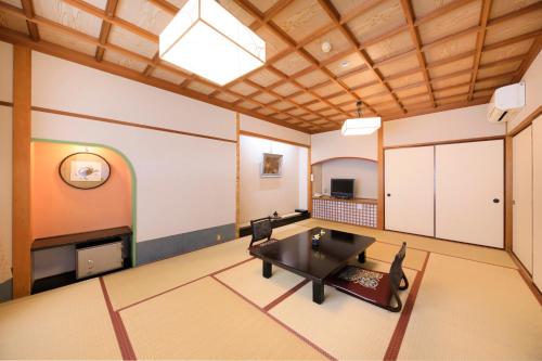 a living room with a table and a fireplace at 日長庵 桂月 in Hirugami