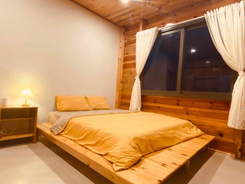 a bedroom with a bed and a window in a room at Lam Nguyên Charming House in Bao Loc