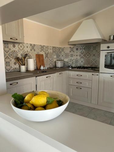 a bowl of lemons on a counter in a kitchen at Casa Dambrosio vacation Breathtaking views in Camerota