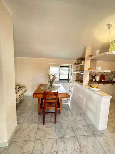 a kitchen and dining room with a table and chairs at Casa Dambrosio vacation Breathtaking views in Camerota