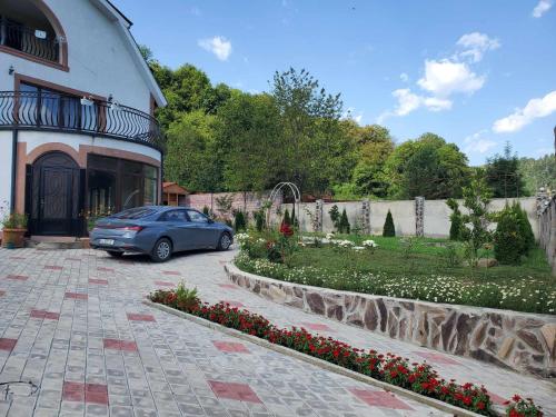 a car parked in front of a house at DIOSKURIA BORJOMi in Borjomi