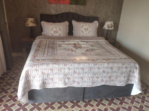 a bedroom with a large bed with two lamps at Tarihi Kumbaba Otel in Sile
