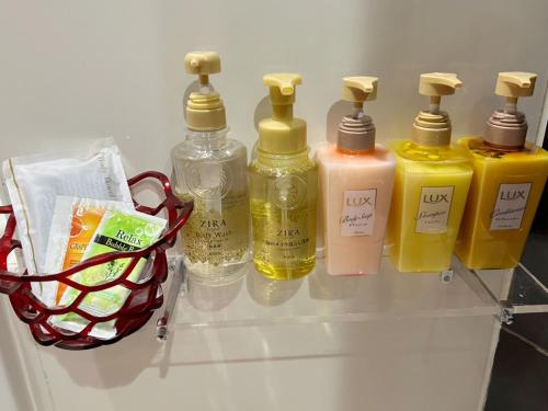 a shelf with four bottles of detergents in a refrigerator at Restay Koakuma (Adult Only) in Utsunomiya