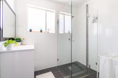 a bathroom with a shower and a glass shower stall at Culture Paradise 3BR 2 story Townhouse Cabramatta in Cabramatta