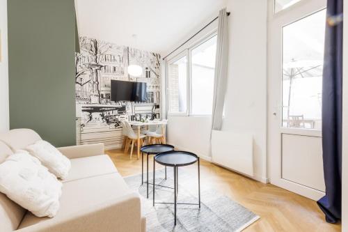 un salon avec un canapé et une table dans l'établissement Appartement Moderne 1BR-4P - Guy Moquet, à Paris