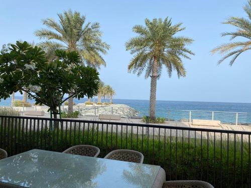 a table and chairs with a view of the ocean at Dream Inn Apartments - Address Beach Residence Fujairah in Fujairah