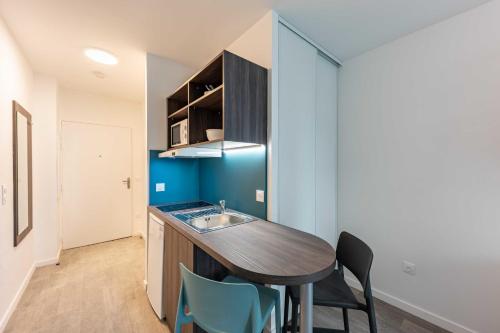 cocina con fregadero y mesa con sillas en Cute Studio close to Paris - 1P - 509 en Ivry-sur-Seine