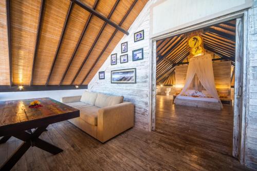 a living room with a couch and a table at Shakti Villa Umalas in Canggu